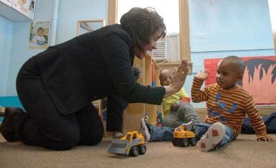This year's Gala Chair Stephanie C. Hill greets a child at House of Ruth