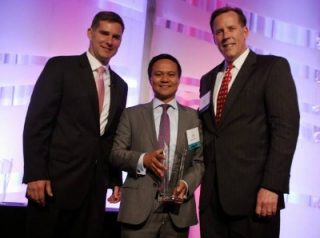 Gala Co-Chairs Cameron Hamilton and Scott Brezler present MicroPact's Kris Collo SECAF's 2014 Government Contractor of the Year ($12 million-$25 million) Award. Photo courtesy of SECAF. 