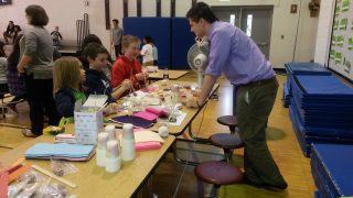 Brady Culman works with students at the 2014 K-12 STEM Symposium