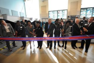 Frank Kendall, center, undersecretary of defense for acquisition, technology and logistics, helps to cut the ceremonial ribbon symbolizing the opening of a FLEX-ACE Lab at Francis L. Cardozo Education Campus. Photo credit: Marvin Lynchard 