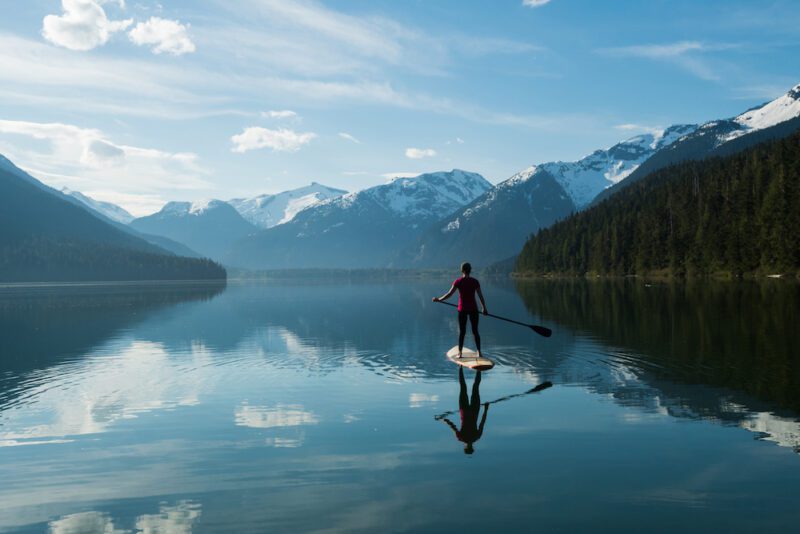 Jessa Gilbert exploring Cheakamus Lake at sunrise by SUP. Mike Crane Photo www.mcranephotography.com